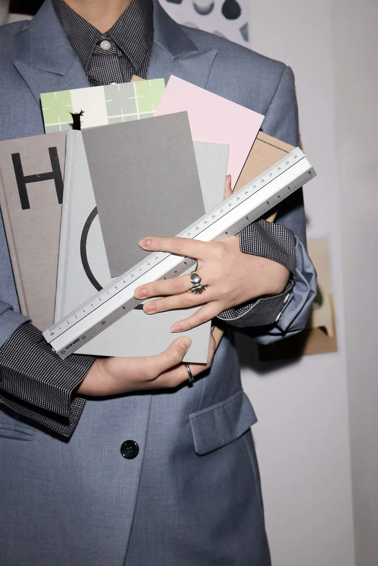 Notebooks, paper samples and a ruler